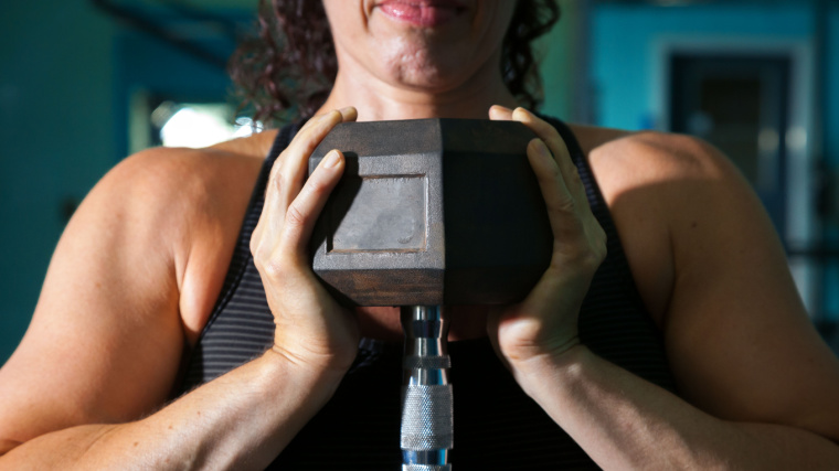 muscular person holding dumbbell